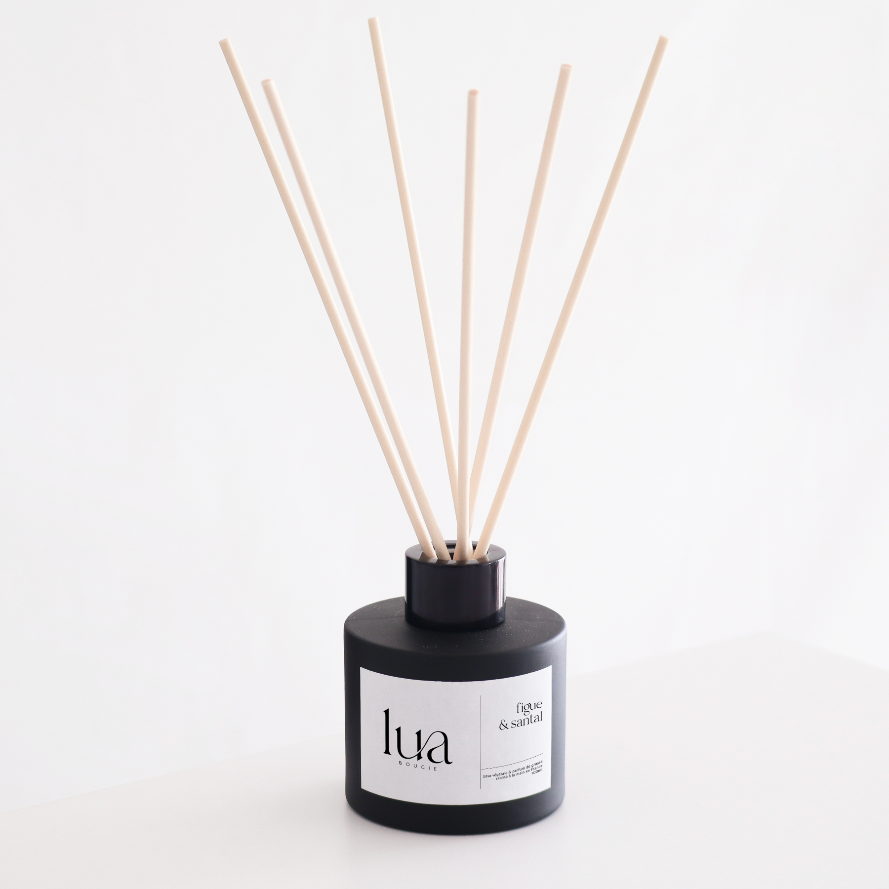 Diffuseur de parfum naturelle LUA Bougie, parfum de Grasse et base végétale. Contenant noir et tige de rotin.